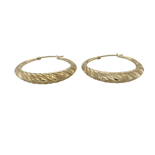 Bring elegant texture and warm golden shine to your collection with these pre-owned 9ct yellow gold patterned twisted creole earrings—an eye-catching pair offering timeless style and refined detail.

Design: These hoop creole earrings feature a twisted shape with decorative patterning, creating depth, movement, and a distinctive light-catching finish.
Material: Made from 9-carat yellow gold, the polished surfaces enhance the rich golden tone and highlight the intricate twist and pattern details.