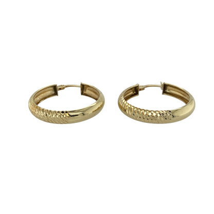 Bring subtle texture and warm golden shine to your collection with these pre-owned 9ct yellow gold half-patterned creole earrings—an elegant pair offering timeless style and refined detail.

Design: These hoop creole earrings feature a half-patterned finish, combining smooth polish with decorative texture for a balanced and eye-catching look.
Material: Made from 9-carat yellow gold, the polished surfaces enhance the rich golden tone while highlighting the patterned detailing.