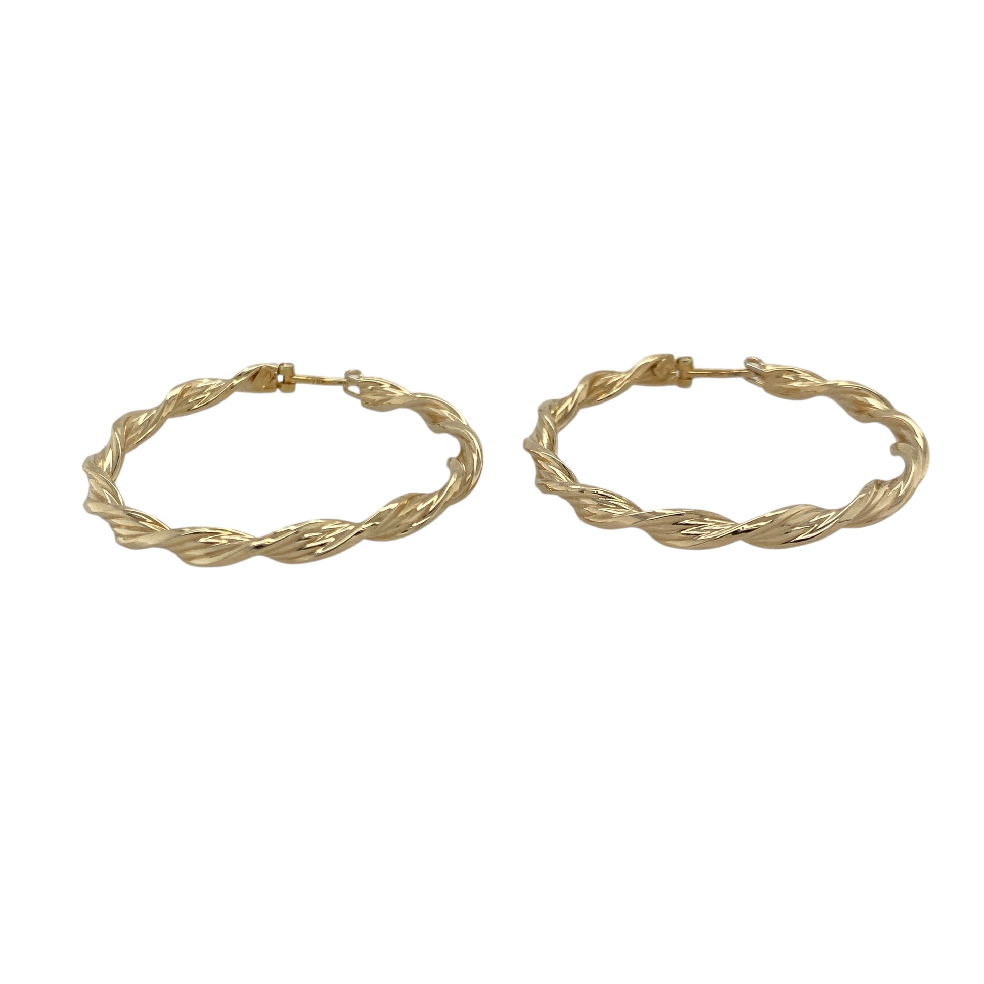 Bring graceful movement and warm golden shine to your collection with these pre-owned 9ct yellow gold ribbon-twisted creole earrings—an elegant pair offering timeless style and refined detail.

Design: These hoop creole earrings feature a flowing ribbon-twist pattern, creating soft curves and light-catching texture for a beautifully feminine look.
Material: Made from 9-carat yellow gold, the polished surfaces enhance their rich golden tone and highlight the twisting design.