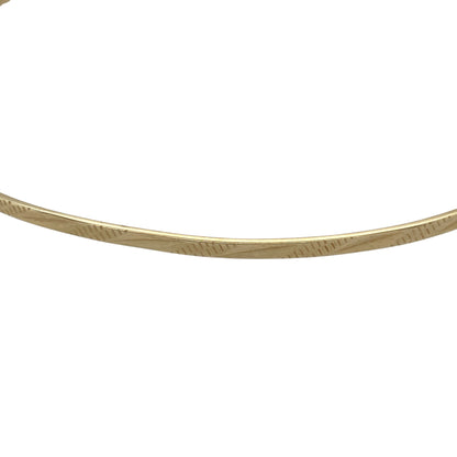 Bring elegant texture and warm golden shine to your collection with this pre-owned 9ct yellow solid gold patterned bangle—an attractive piece offering timeless style and refined detail.

Design: This bangle features a delicate 2mm patterned finish, adding subtle depth and visual interest to its classic circular form.
Material: Made from solid 9-carat yellow gold, the polished surface enhances its radiant, long-lasting shine.