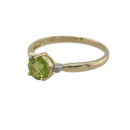 Bring fresh colour and delicate sparkle to your collection with this pre-owned 9ct yellow gold peridot and diamond ring—an elegant piece offering timeless charm and refined detail.

Design: This size N ring features a 6mm round peridot at the centre, displaying its bright green tone, complemented by diamonds that add subtle brilliance and balance.
Material: Made from 9-carat yellow gold, the polished finish enhances the warm golden tone of the band and beautifully complements the vivid peridot.