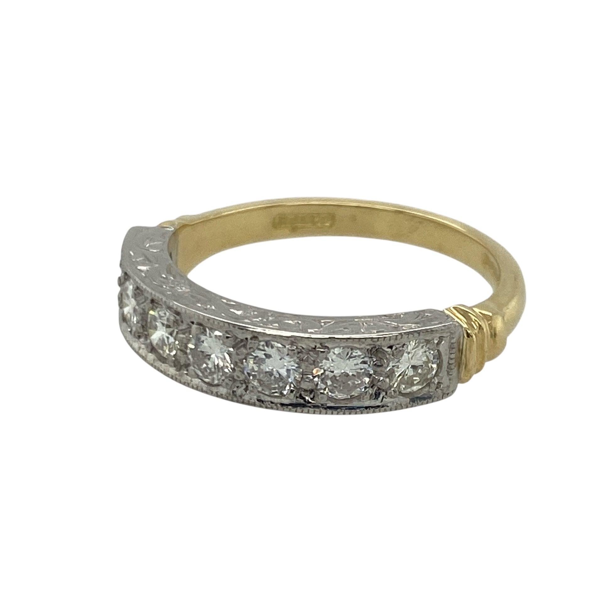Bring exceptional brilliance and timeless elegance to your collection with this pre-owned 18ct yellow and white gold seven-stone diamond band ring—an exquisite piece offering luxurious sparkle and refined style.

Design: This size M band features a 6mm wide front set with seven brilliant-cut diamonds, each approximately 0.11ct, creating a beautifully balanced row of bright, continuous sparkle.