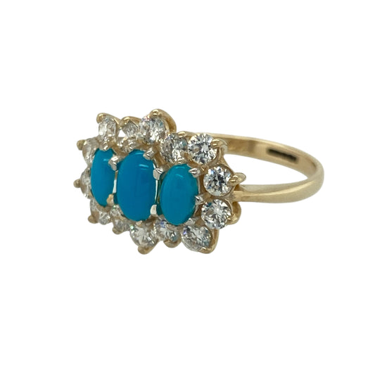 Bring vibrant colour and elegant sparkle to your collection with this pre-owned 9ct yellow gold turquoise and cubic zirconia cluster ring—an attractive piece offering timeless charm and refined detail.

Design: This size M–N ring features a 6mm by 4mm turquoise-coloured centre stone surrounded by a cluster of cubic zirconia, creating a bright, eye-catching display with a classic clustered finish.
Material: Made from 9-carat yellow gold