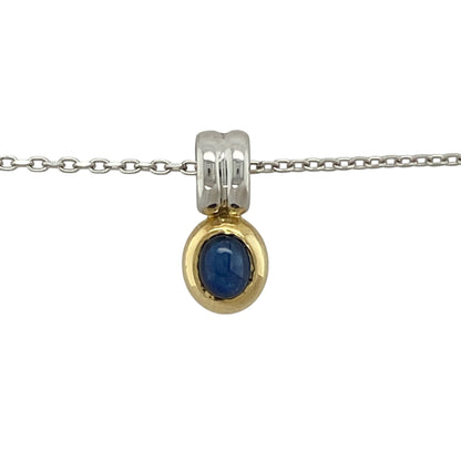 Bring elegant colour and refined two-tone detail to your collection with this pre-owned 18ct white and yellow gold blue stone pendant necklace—an attractive piece offering timeless beauty and graceful sophistication.

Design: This oval pendant features a 5mm by 4mm sapphire-coloured blue stone framed in a smooth, classic setting, creating a bright and beautifully balanced focal point.