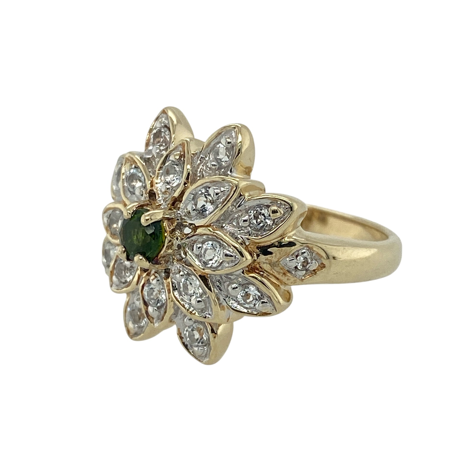 Bring vibrant colour and vintage-inspired charm to your jewellery collection with this pre-owned 9ct yellow gold green stone and cubic zirconia flower cluster ring — a striking piece with bold presence and sparkling detail.

Design: The front of the ring measures 19mm high and features a floral-style cluster with a 4mm round green centre stone surrounded by sparkling cubic zirconia, creating a bright and eye-catching display.