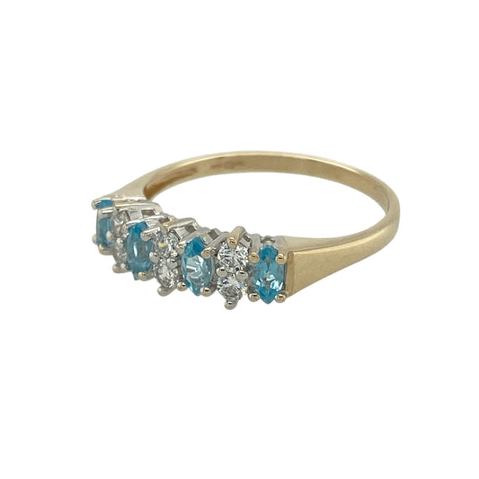 Bring vibrant colour and elegant sparkle to your jewellery collection with this pre-owned 9ct yellow gold blue stone and cubic zirconia band ring — a graceful piece with timeless charm.

Design: The ring features marquise-cut blue stones, each measuring 4mm by 2mm, arranged along the band with two round cubic zirconia set between each for a bright, balanced look.