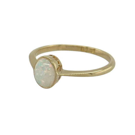 Bring soft colour and classic elegance to your jewellery collection with this pre-owned 18ct yellow gold opalique solitaire ring — a delicate piece with a gentle, iridescent glow.

Design: The ring features a 7mm by 5mm opalique stone, offering a smooth oval shape with luminous colour play for a graceful and captivating focal point.
Material: Made from 18ct yellow gold, the polished finish enhances the warm tone of the band and beautifully complements the soft shimmer of the opalique.