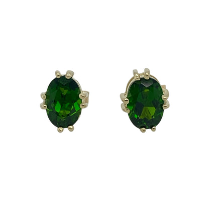 Bring rich colour and refined elegance to your accessory collection with these pre-owned 9ct gold oval green stone stud earrings — a vibrant pair with timeless appeal.

Design: Each earring features a 7mm by 5mm oval chrome-diopside–coloured green stone, offering deep, vivid colour in a classic and eye-catching stud style.
Material: Made from 9ct gold, the polished finish provides a warm contrast that enhances the striking green tones of the stones.