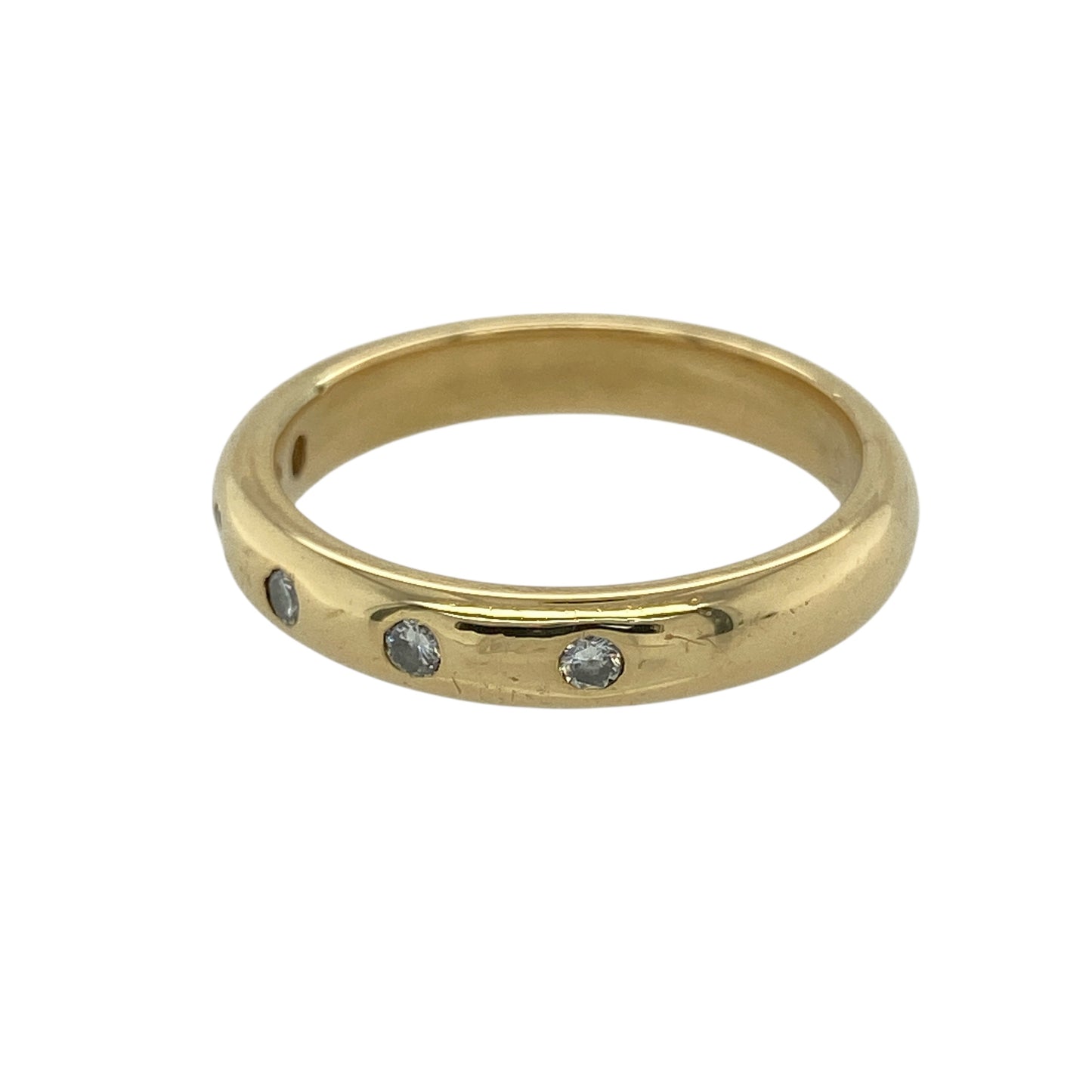 Bring timeless sparkle and refined luxury to your jewellery collection with this pre-owned 18ct yellow gold diamond band ring — a classic piece with elegant brilliance.

Design: The 4mm wide band features five diamonds arranged neatly across the front, offering balanced sparkle and a clean, sophisticated look.
Material: Made from 18ct yellow gold, the rich polished finish enhances the warm tone of the band and beautifully complements the bright diamonds.