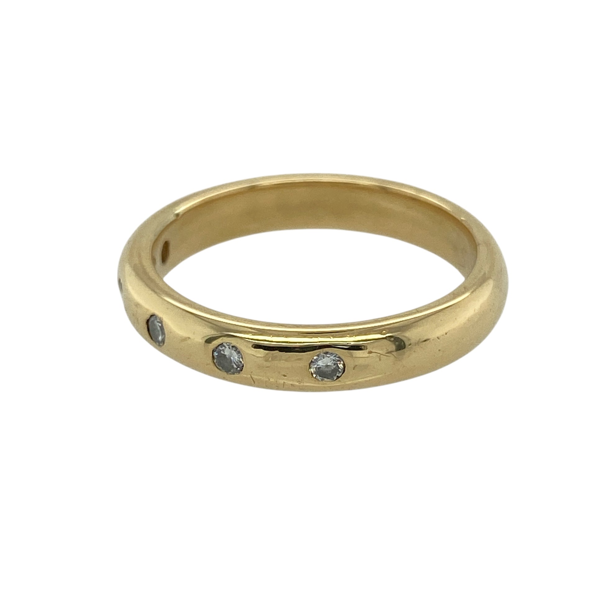 Bring timeless sparkle and refined luxury to your jewellery collection with this pre-owned 18ct yellow gold diamond band ring — a classic piece with elegant brilliance.

Design: The 4mm wide band features five diamonds arranged neatly across the front, offering balanced sparkle and a clean, sophisticated look.
Material: Made from 18ct yellow gold, the rich polished finish enhances the warm tone of the band and beautifully complements the bright diamonds.