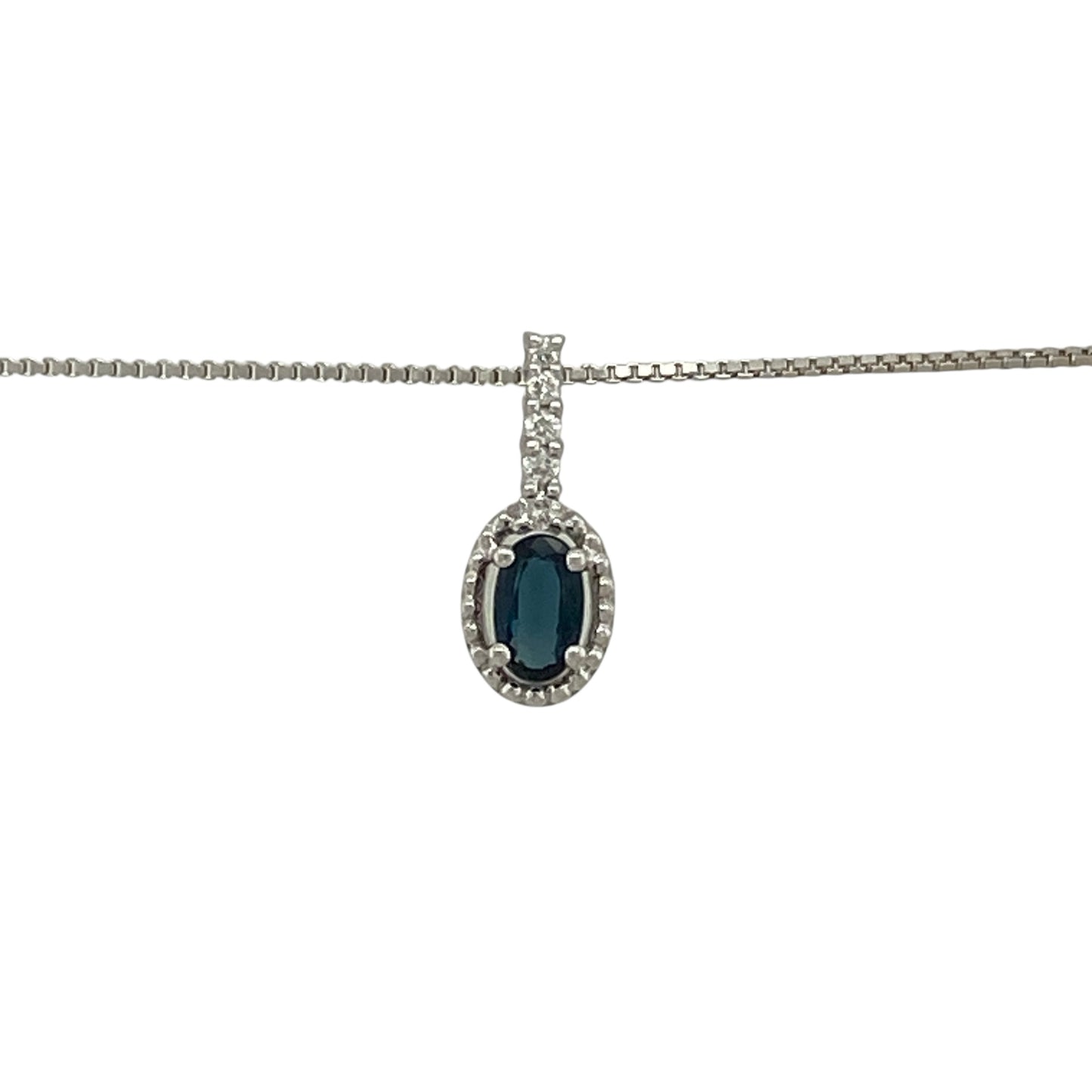 Bring refined colour and elegant sparkle to your jewellery collection with this pre-owned 18ct white gold diamond and sapphire halo pendant on an 18" box chain — a timeless piece with classic sophistication.

Design: The pendant measures 1.3cm in length including the bail and features a 5mm by 3mm oval sapphire at the centre, surrounded by a shimmering halo of diamonds for a bright and elegant finish.