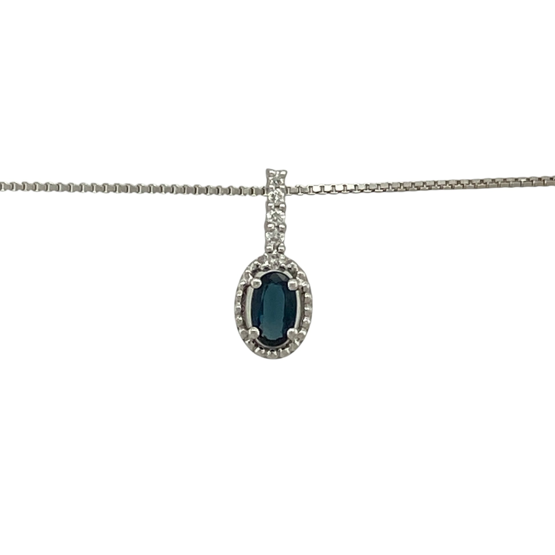 Bring refined colour and elegant sparkle to your jewellery collection with this pre-owned 18ct white gold diamond and sapphire halo pendant on an 18" box chain — a timeless piece with classic sophistication.

Design: The pendant measures 1.3cm in length including the bail and features a 5mm by 3mm oval sapphire at the centre, surrounded by a shimmering halo of diamonds for a bright and elegant finish.