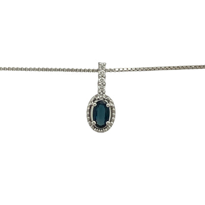 Bring refined colour and elegant sparkle to your jewellery collection with this pre-owned 18ct white gold diamond and sapphire halo pendant on an 18" box chain — a timeless piece with classic sophistication.

Design: The pendant measures 1.3cm in length including the bail and features a 5mm by 3mm oval sapphire at the centre, surrounded by a shimmering halo of diamonds for a bright and elegant finish.