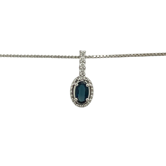 Bring refined colour and elegant sparkle to your jewellery collection with this pre-owned 18ct white gold diamond and sapphire halo pendant on an 18" box chain — a timeless piece with classic sophistication.

Design: The pendant measures 1.3cm in length including the bail and features a 5mm by 3mm oval sapphire at the centre, surrounded by a shimmering halo of diamonds for a bright and elegant finish.