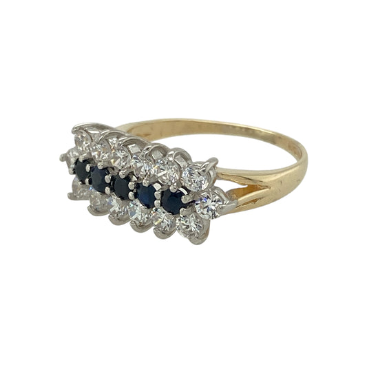 Bring rich colour and elegant sparkle to your jewellery collection with this pre-owned 9ct yellow gold sapphire and cubic zirconia cluster band ring — a refined piece with classic charm and eye-catching detail.

Design: The front of the ring measures 7mm high and features a central row of deep blue sapphires, beautifully framed above and below by shimmering cubic zirconia for a bright, balanced cluster effect.