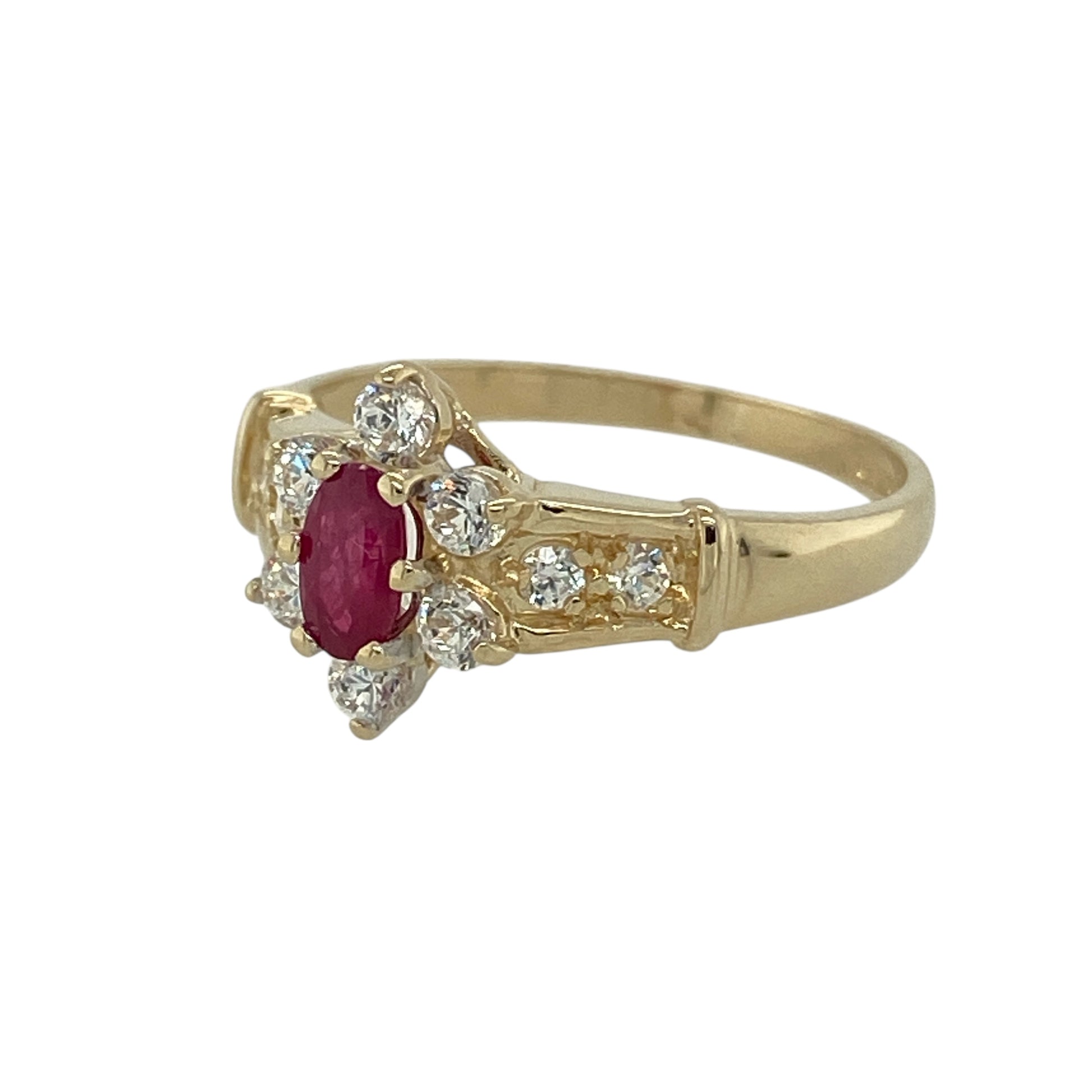 Bring vibrant colour and timeless elegance to your collection with this pre-owned 9ct yellow gold ruby and cubic zirconia cluster ring—an eye-catching piece that balances rich tones with refined sparkle.

Design: This classic cluster ring showcases a 5mm by 3mm oval ruby at the centre, surrounded by a halo of bright cubic zirconia stones that enhance its deep red hue. The arrangement creates a traditional, graceful silhouette with beautiful light play.