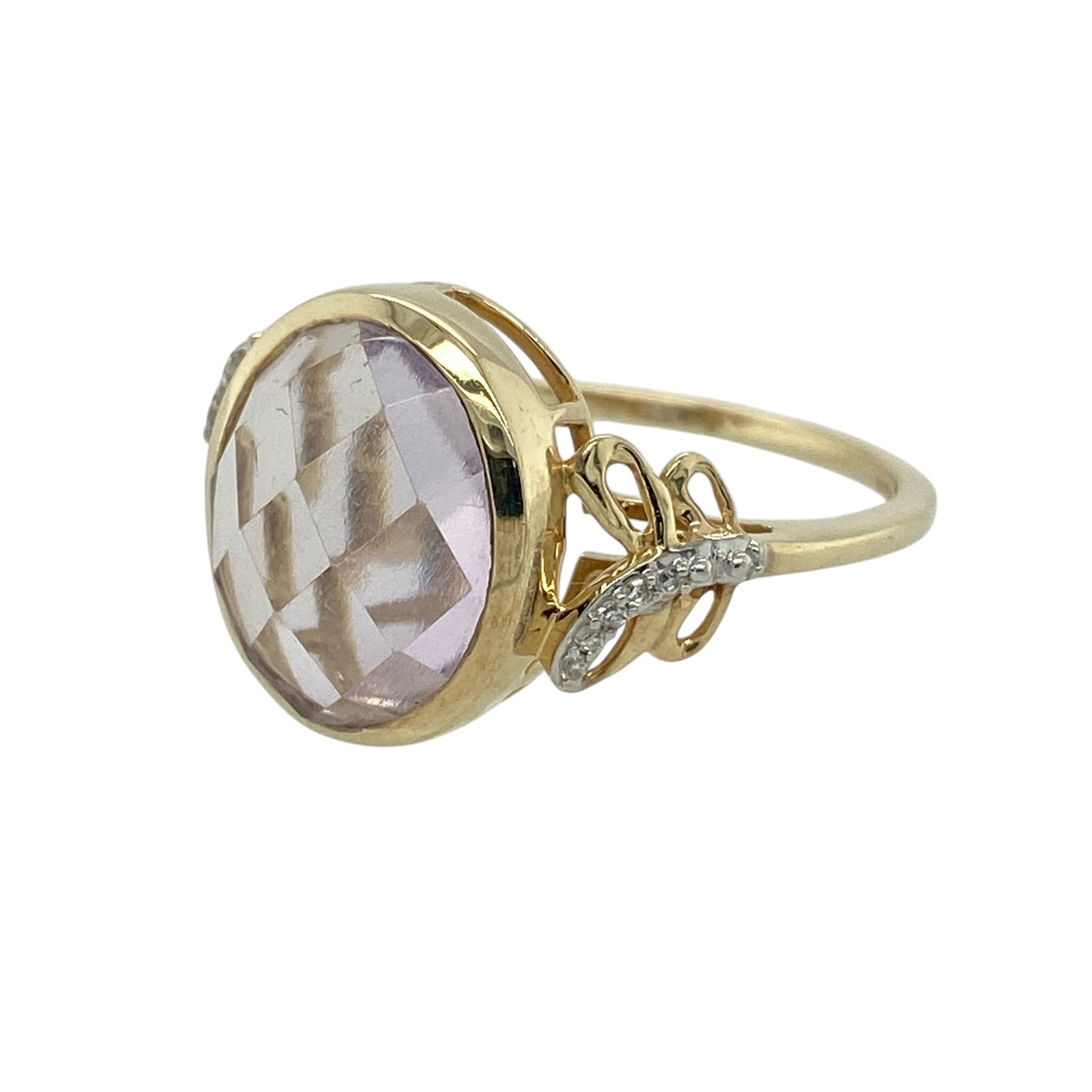 Bring bold colour and refined sparkle to your collection with this pre-owned 9ct yellow gold diamond and purple stone ring—an elegant piece that pairs striking presence with timeless golden warmth.

Design: This eye-catching ring features a generous 12mm by 10mm oval purple stone at the centre, creating a vivid focal point with beautiful depth of colour. The shoulders are adorned with a diamond-set swirl pattern, adding gentle sparkle and enhancing the ring’s graceful, flowing silhouette.