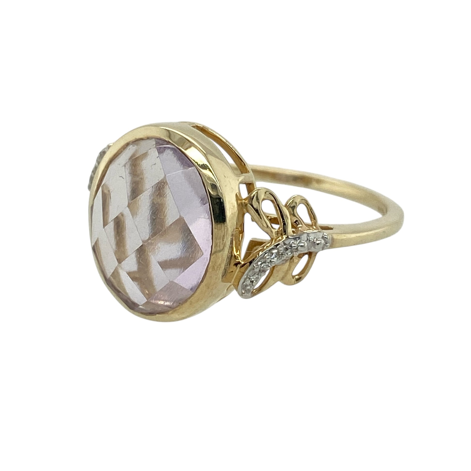 Bring bold colour and refined sparkle to your collection with this pre-owned 9ct yellow gold diamond and purple stone ring—an elegant piece that pairs striking presence with timeless golden warmth.

Design: This eye-catching ring features a generous 12mm by 10mm oval purple stone at the centre, creating a vivid focal point with beautiful depth of colour. The shoulders are adorned with a diamond-set swirl pattern, adding gentle sparkle and enhancing the ring’s graceful, flowing silhouette.