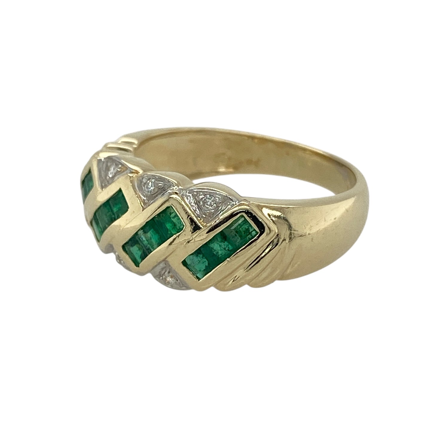 Bring rich colour and refined sparkle to your collection with this pre-owned 14ct yellow gold diamond and emerald band ring—an elegant piece that blends timeless gemstones with a bold, luxurious presence.

Design: The front of the band measures 8mm wide and features a striking arrangement of princess-cut emeralds, offering vibrant green colour and clean geometric lines. Small diamonds are set along the top and bottom edges, adding subtle brilliance and enhancing the ring’s structured, sophisticated style.