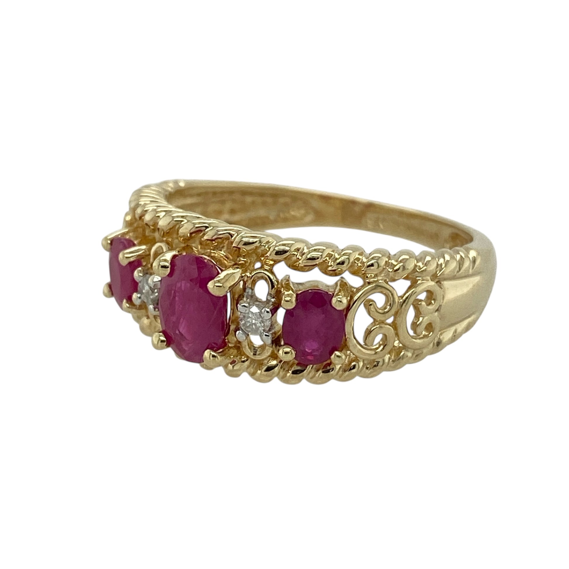Bring rich colour and refined sparkle to your collection with this pre-owned 9ct yellow gold diamond and ruby band ring—an elegant piece with classic gemstones and a bold band profile.

Design: The front of the band measures 9mm wide and features a 6mm by 4mm oval ruby at the centre, offering deep red colour and a striking focal point. Diamonds are arranged around the ruby, adding bright contrast and enhancing the ring’s balanced, graceful design.