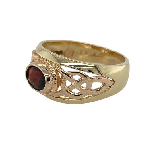 Bring rich colour and meaningful heritage to your collection with this pre-owned 9ct yellow and rose gold Clogau Celtic ring—an elegant piece that pairs vibrant gemstone beauty with symbolic design.

Design: This refined ring features a 7mm by 5mm oval garnet at the centre, offering deep red brilliance framed by an intricate Celtic-inspired motif. The flowing pattern adds depth and character, giving the ring a timeless and expressive look.