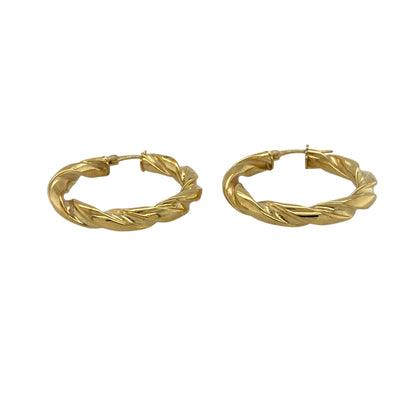Bring classic style and elegant texture to your collection with these pre-owned 9ct yellow gold twisted hoop creole earrings—timeless pieces with a refined, polished finish.

Design: These hoops feature a twisted creole design, adding subtle texture and visual interest while maintaining a clean, traditional silhouette. Their smooth curvature and polished surface create a warm, radiant shine.
