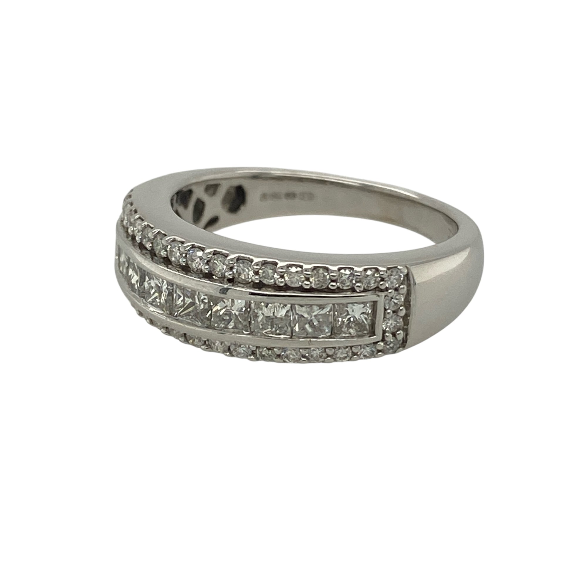 Bring bold luxury and exceptional sparkle to your jewellery collection with this pre-owned 18ct white gold & diamond set band ring, offering an eye-catching design with impressive presence.

Design: The ring features a wide band with a striking diamond arrangement, showcasing a central panel of princess-cut diamonds framed by brilliant-cut diamonds for maximum impact.