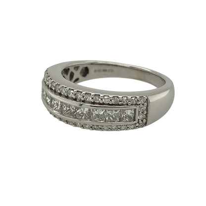 Bring bold luxury and exceptional sparkle to your jewellery collection with this pre-owned 18ct white gold & diamond set band ring, offering an eye-catching design with impressive presence.

Design: The ring features a wide band with a striking diamond arrangement, showcasing a central panel of princess-cut diamonds framed by brilliant-cut diamonds for maximum impact.