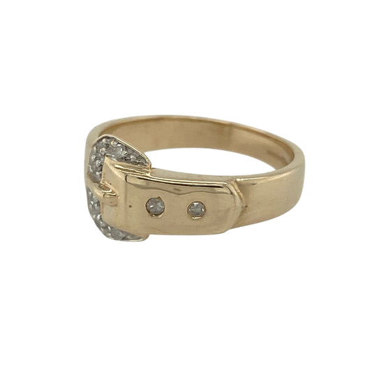 Bring timeless symbolism and classic elegance to your jewellery collection with this pre-owned 9ct yellow gold & diamond set buckle ring, offering a distinctive design with refined sparkle.

Design: The ring features a traditional buckle motif to the front, symbolising strength and commitment, accented with diamond detailing for subtle brilliance.
Material: Made from 9-carat yellow gold, the warm polished finish enhances the character of the buckle design and the sparkle of the diamonds.