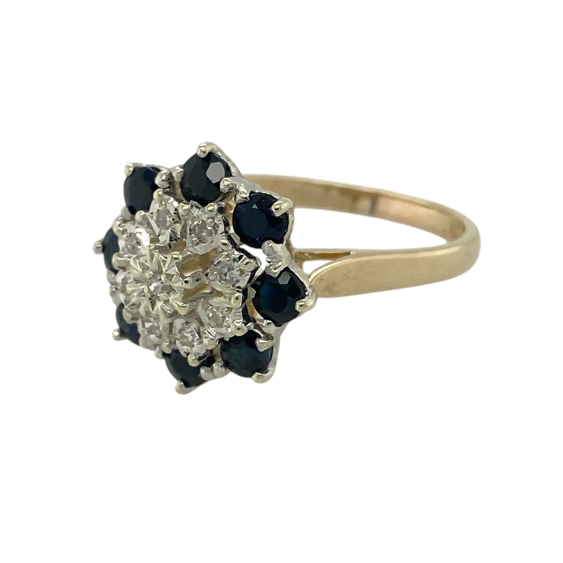 Bring vibrant colour and classic floral elegance to your jewellery collection with this pre-owned 9ct yellow and white gold diamond & sapphire set flower cluster ring, offering bold design with refined sparkle.

Design: The ring features a striking flower cluster arrangement, with rich blue sapphires and sparkling diamonds forming a beautifully balanced floral motif at the front.