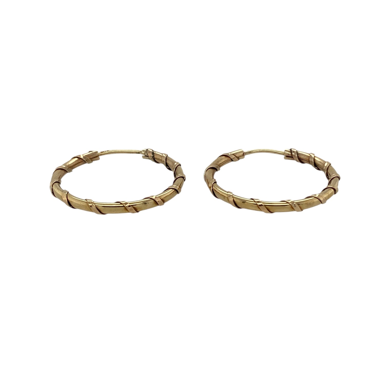 Bring timeless style and subtle texture to your jewellery collection with these pre-owned 9ct yellow gold twist hoop earrings, offering classic elegance with a refined finish.

Design: The earrings feature a twist hoop design, adding gentle texture and visual interest to the traditional hoop silhouette.
Material: Made from 9-carat yellow gold, the warm polished finish enhances the twisted detailing and gives the earrings a rich golden glow.