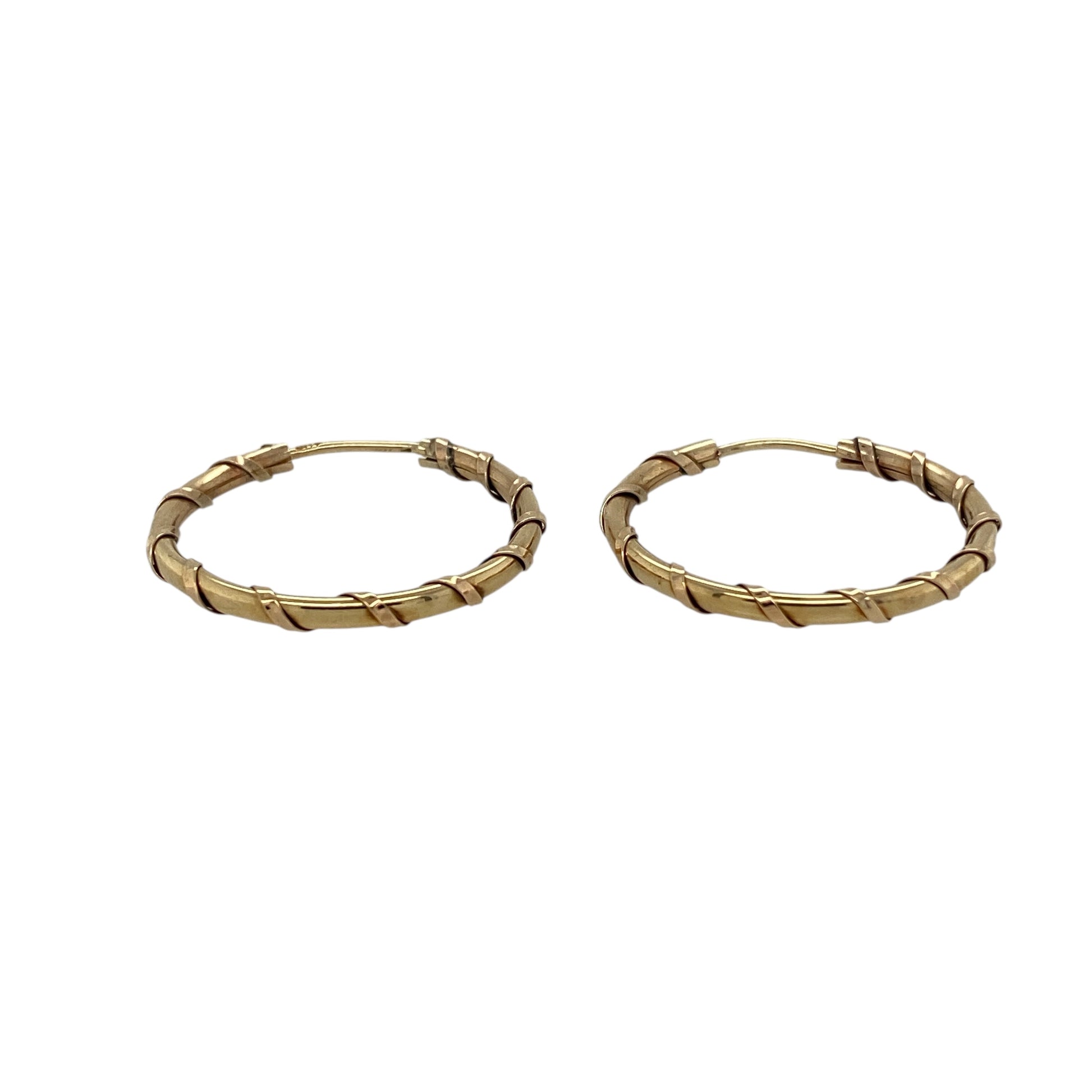 Bring timeless style and subtle texture to your jewellery collection with these pre-owned 9ct yellow gold twist hoop earrings, offering classic elegance with a refined finish.

Design: The earrings feature a twist hoop design, adding gentle texture and visual interest to the traditional hoop silhouette.
Material: Made from 9-carat yellow gold, the warm polished finish enhances the twisted detailing and gives the earrings a rich golden glow.