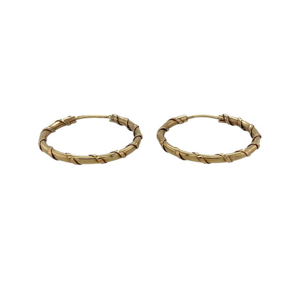 Bring timeless style and subtle texture to your jewellery collection with these pre-owned 9ct yellow gold twist hoop earrings, offering classic elegance with a refined finish.

Design: The earrings feature a twist hoop design, adding gentle texture and visual interest to the traditional hoop silhouette.
Material: Made from 9-carat yellow gold, the warm polished finish enhances the twisted detailing and gives the earrings a rich golden glow.