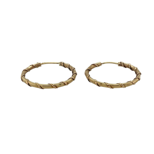 Bring timeless style and subtle texture to your jewellery collection with these pre-owned 9ct yellow gold twist hoop earrings, offering classic elegance with a refined finish.

Design: The earrings feature a twist hoop design, adding gentle texture and visual interest to the traditional hoop silhouette.
Material: Made from 9-carat yellow gold, the warm polished finish enhances the twisted detailing and gives the earrings a rich golden glow.