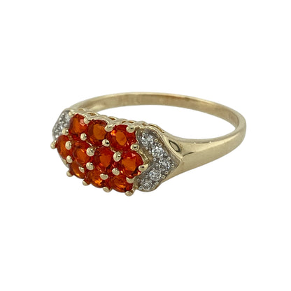 Bring warm colour and refined sparkle to your jewellery collection with this pre-owned 9ct yellow gold diamond & orange stone ring, offering a vibrant and elegant design.

Design: The ring features a bright arrangement of orange stones accented with diamonds, creating a lively and eye-catching focal point across the front.
Material: Made from 9-carat yellow gold, the warm polished finish beautifully complements the rich orange tones and the sparkle of the diamonds.