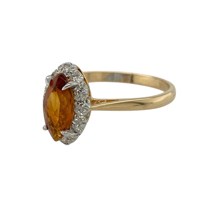 Bring warm colour and eye-catching sparkle to your jewellery collection with this pre-owned 9ct yellow gold diamond & orange stone marquise cluster ring, offering bold design with elegant detail.

Design: The ring features a marquise-cut orange centre stone framed by a cluster of diamonds, creating a striking and elongated focal point across the finger.