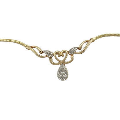 Bring romantic elegance and subtle sparkle to your jewellery collection with this pre-owned 9ct yellow and white gold & diamond set heart drop necklace, offering timeless charm with a refined finish.

Design: The necklace features a delicate heart-shaped drop pendant, accented with diamond detail for gentle sparkle, suspended from a sleek flat snake chain for a modern and elegant look.
