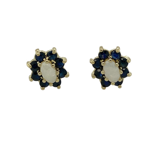Bring soft iridescence and rich colour to your jewellery collection with these pre-owned 9ct yellow gold sapphire & opalique set cluster stud earrings, offering elegant contrast with timeless charm.

Design: The earrings feature a classic cluster stud style, with luminous opalique centre stones surrounded by deep blue sapphires to create a refined and eye-catching look.