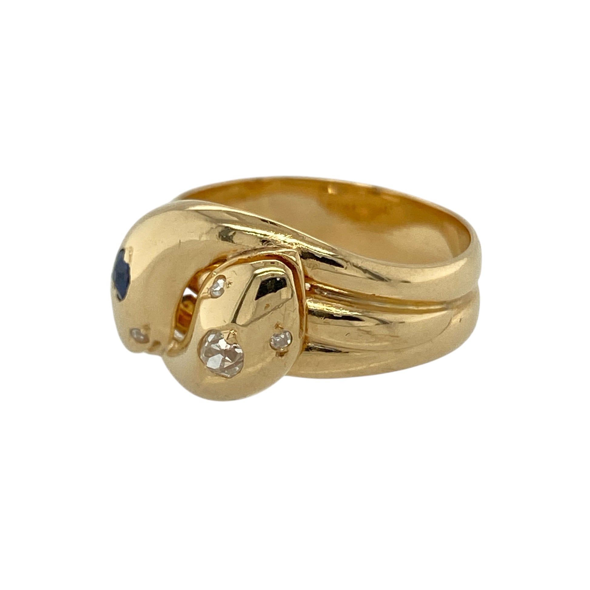 Bring symbolic elegance and vintage-inspired character to your jewellery collection with this pre-owned 18ct yellow gold diamond and sapphire set double head snake ring, a striking and meaningful design with timeless appeal.

Design: The ring features a distinctive double head snake motif, with each head meeting at the front of the band. One head is highlighted with a sapphire measuring approximately 2mm