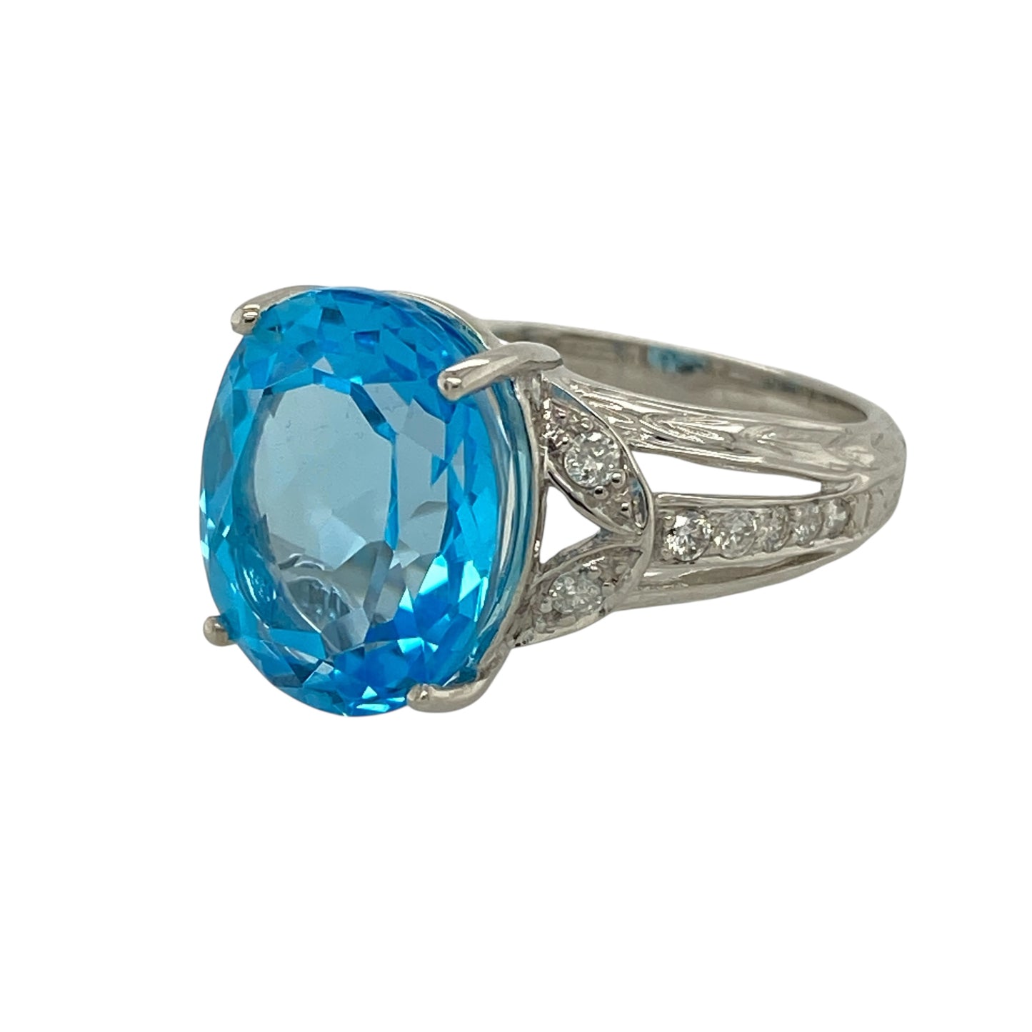 Bring cool-toned elegance and striking gemstone presence to your jewellery collection with this pre-owned 18ct white gold diamond and blue topaz set ring, a refined design that blends bold colour with classic sparkle.

Design: The ring features a large blue topaz as the focal point, measuring approximately 13mm by 11mm, offering a beautifully proportioned and eye-catching centre. Diamond accents add subtle brilliance, enhancing the stone’s vibrant blue hue.
