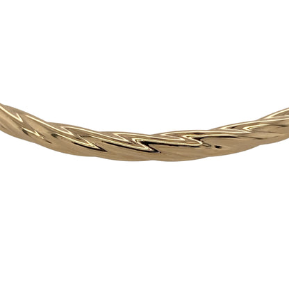Bring graceful texture and classic gold style to your jewellery collection with this pre-owned 9ct yellow hollow gold twisted bangle, a lightweight and elegant piece perfect for everyday wear.

Design: The bangle features a twisted design that adds flowing texture and visual interest to its sleek profile. Measuring approximately 4mm in width, it offers a refined and delicate presence on the wrist.