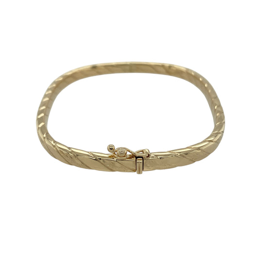 Bring refined structure and elegant texture to your jewellery collection with this pre-owned 9ct yellow gold twisted squared hinged bangle, a stylish piece that combines classic gold with a contemporary edge.

Design: The bangle features a squared profile with a twisted design, adding depth and visual interest while maintaining clean, defined lines. Measuring approximately 5mm in width, it offers a balanced and distinctive presence on the wrist.