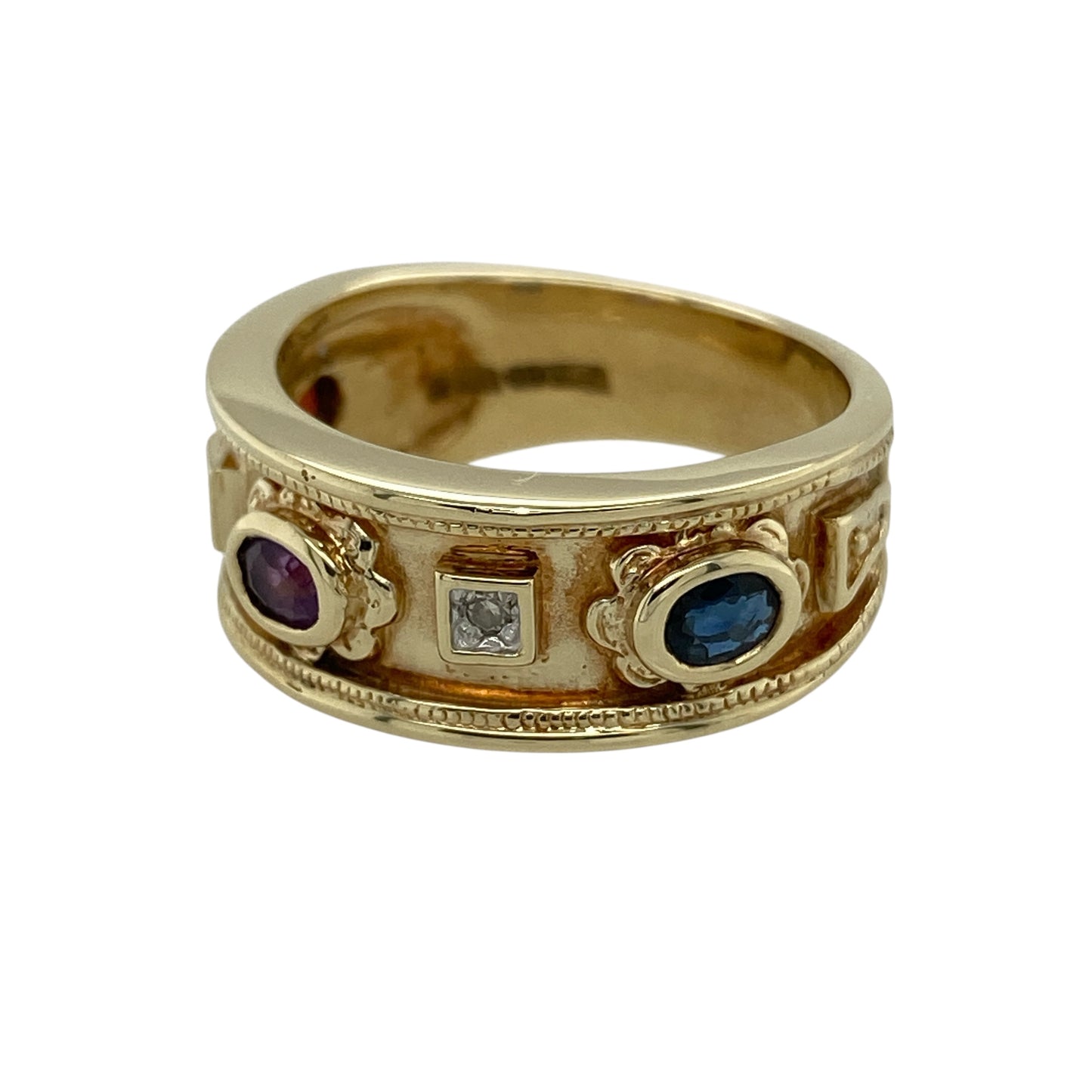 Bring rich colour and elegant sparkle to your jewellery collection with this pre-owned 9ct yellow gold diamond & gemstone band ring, a bold yet refined design that blends classic gold with vibrant stones.

Design: The front of the band measures 8mm wide and features a trio of oval-cut gemstones—a deep red garnet, a rich purple amethyst, and a striking blue sapphire—each complemented by diamonds that add subtle brilliance to the design.