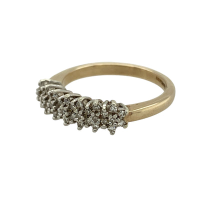 Bring classic sparkle and everyday elegance to your jewellery collection with this pre-owned 9ct yellow gold diamond cluster band ring, a timeless design with a refined yet eye-catching finish.

Design: The front of the band measures 5mm wide and features a cluster of diamonds that create a concentrated sparkle across the centre of the ring.
Material: Made from polished 9-carat yellow gold, the warm golden tone enhances the brilliance of the diamonds and offers a classic look.