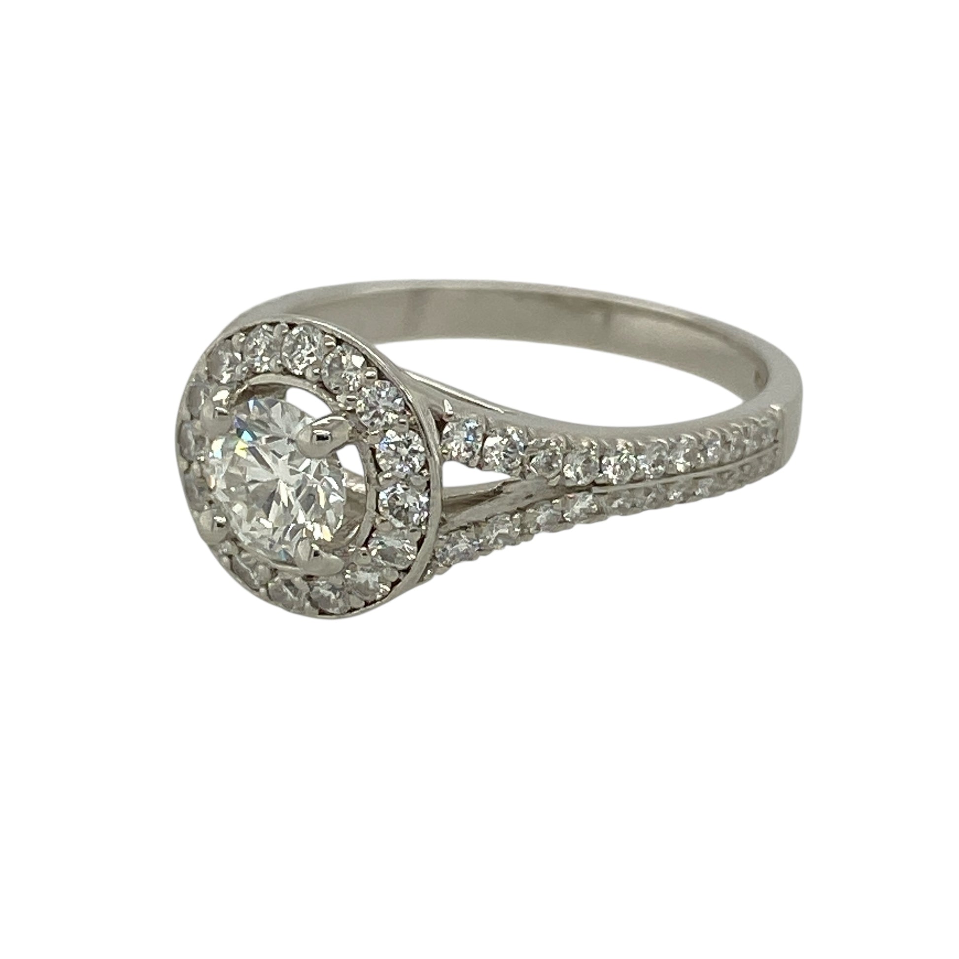 Bring exceptional brilliance and timeless sophistication to your jewellery collection with this pre-owned platinum diamond halo ring, a luxurious design that showcases impressive diamond sparkle with enduring elegance.

Design: The ring features a central diamond of approximately 0.46ct, encircled by a halo of smaller diamonds that enhance its size and radiance, creating a striking and well-balanced focal point.