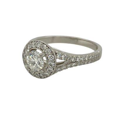 Bring exceptional brilliance and timeless sophistication to your jewellery collection with this pre-owned platinum diamond halo ring, a luxurious design that showcases impressive diamond sparkle with enduring elegance.

Design: The ring features a central diamond of approximately 0.46ct, encircled by a halo of smaller diamonds that enhance its size and radiance, creating a striking and well-balanced focal point.