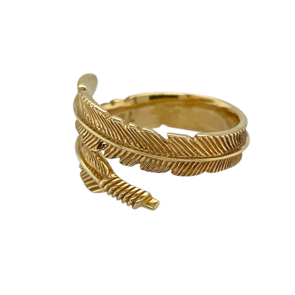 Bring graceful detail and symbolic elegance to your jewellery collection with this pre-owned 18ct yellow gold feather wrap around ring, a distinctive design that blends fluid form with timeless style.

Design: The ring features a feather-inspired wrap-around design, with the front of the band measuring 9mm wide and creating a bold yet elegant focal point on the finger.