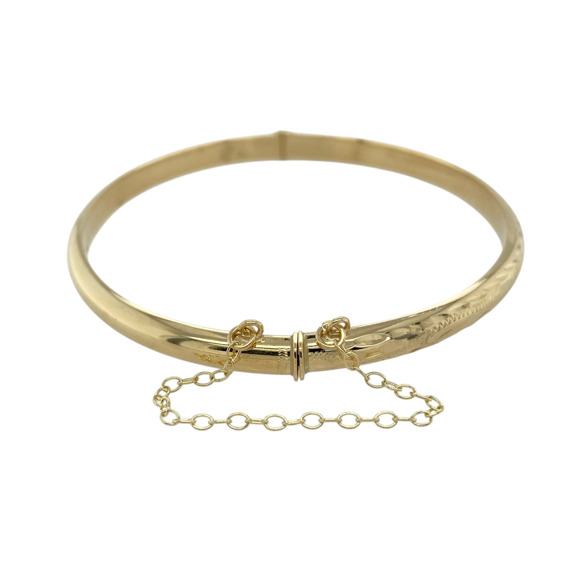 Bring classic elegance and practical design to your jewellery collection with this pre-owned 9ct yellow gold patterned hinged bangle, a timeless piece with refined detailing and secure wear.

Design: The bangle features a patterned finish across a 5mm wide band, offering subtle texture and visual interest. The hinged design allows for easy wear, while the integrated safety chain provides added security.