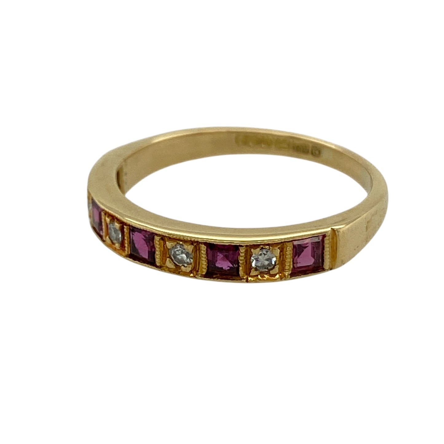 Bring rich colour and refined sparkle to your jewellery collection with this pre-owned 18ct yellow gold diamond & ruby set band ring, a timeless design that balances elegance with vibrant detail.

Design: The front of the band measures 3mm wide and features square-cut rubies arranged in a clean, structured line, accented with diamonds for added brilliance.
