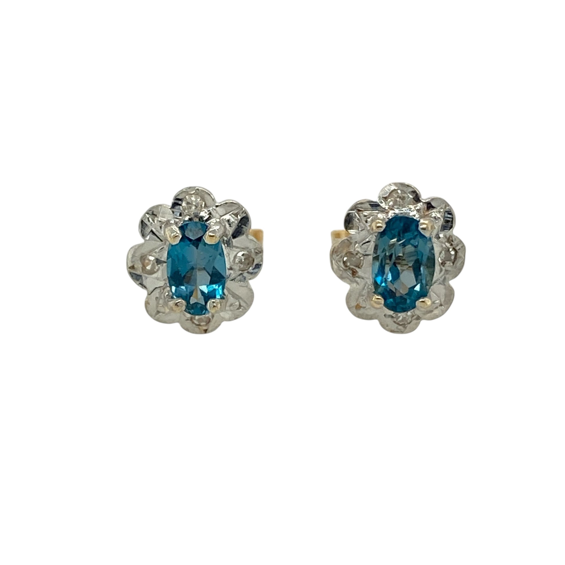 Bring delicate charm and soft colour to your jewellery collection with these pre-owned 9ct yellow and white gold diamond & blue topaz set flower stud earrings, a beautifully balanced design with timeless appeal.

Design: Each stud features a floral-inspired arrangement centred with an oval blue topaz measuring 4mm by 3mm, complemented by diamond accents that add gentle sparkle.